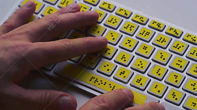 Blind person man hands using computer braille keyboard or terminal a technology device, disabilities