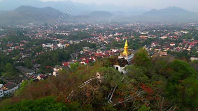 Aerial view of golden stupa on hill in Luang Prabang, Laos