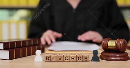 Judge reviews divorce case files in a courtroom setting with gavel and legal books present