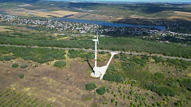 erial drone footage of wind turbine in countryside generating renewable energy