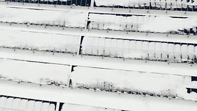 Flying over the farm solar panels in the winter after the cyclone. Panels under the snow.