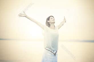 Beautifull woman taking a deep breath at the sunset