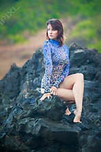 Gymnast girlgymnast girl sitting on a stone