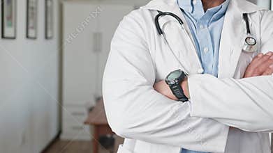 Confident Doctor Standing with Arms Crossed in a Clinic Setting, Ready to Provide Medical Care