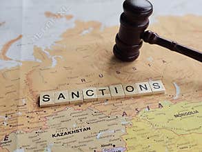 Map shows Russia and nearby countries with the word sanctions spelled out with wooden letters