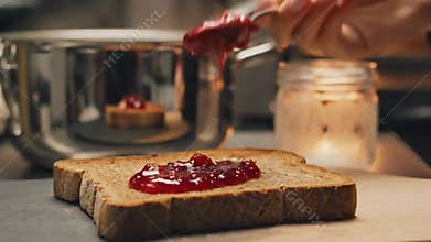 Chef Preparing Gourmet Toast By Spreading Red Strawberry Jam On Bread And Baking It In Fire Oven For Breakfast In Cozy Kitchen