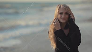 Girl with long blond hair walking along the