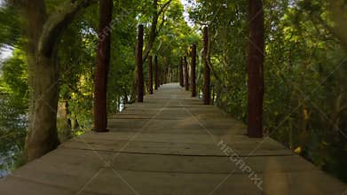 Dangerous running on a high bridge over the lake and forest. Cambodia