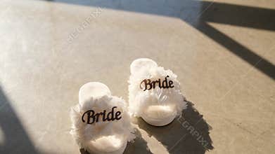 White fluffy slippers for the bride's wedding day preparation