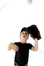 Young boy baseball player focused on catching the baseball