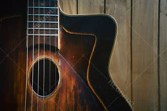 Details of an old jazz guitar on a wooden wall