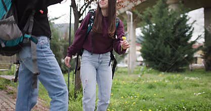Two Young Women with Backpacks Taking Selfies and