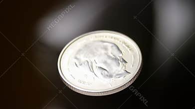 Coin Spinning Imagery. Closeup Of Metallic Coin In Rotation With Dramatic Lighting And Blurred Backdrop