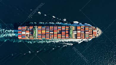 Aerial overhead view of a cargo container ship travling over the ocean as a concept for industry and shipping