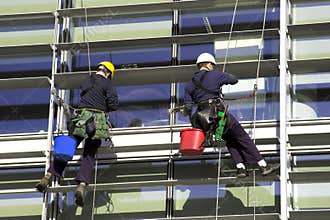Workmen Abseiling A Corporate Building
