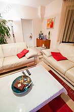 Modern White Living Room with Red Accents