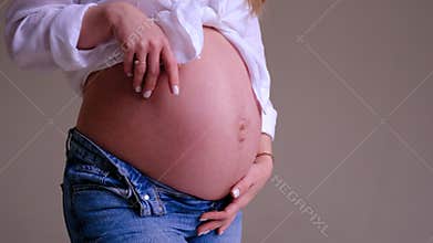 Pregnant woman on a light background. Selective focus.