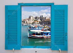 Window with old port of Heraklion, Crete, Greece