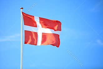 Danish flag with blue sky on background