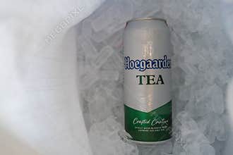 Bangkok, Thailand - March 31, 2026 : Hoegaarden TEA, Jasmine Oolong Tea, 500ml cans placed on ice, 500ml cans