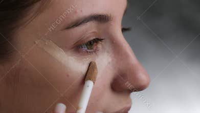 Girl Applying Foundation With Makeup Brush