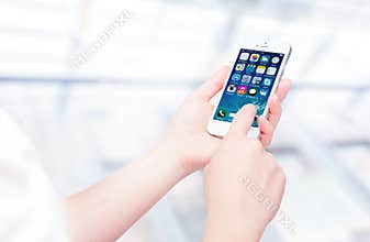 Russia, Chelyabinsk, September 8, 2014. Person holding a new white Apple iPhone 5S, smartphone in part of the iPhone line. Develo