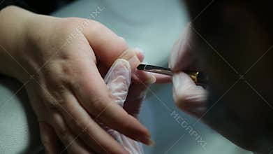 professional hand and nail manicure at a beauty salon. Focus on female hands, skincare, and nail care treatment
