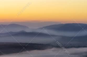 First rays of the rising sun over the mountain