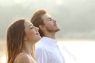 Couple of man and woman breathing deep fresh air