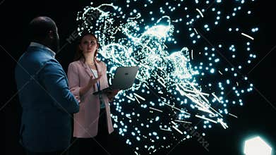 Team of programmers optimizing neural network neurons map with laptop and AR