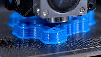 Printing Small Blue Object With a 3D Printer in Close Up