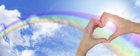 Healing hands on blue sky and rainbow banner