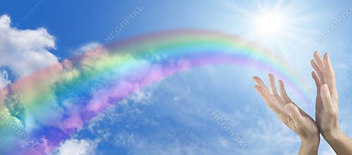 Healing hands on blue sky and rainbow banner