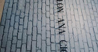 Sophisticated Brick Flooring Accompanied by Stylish Salon Ana Signage for Visual Appeal