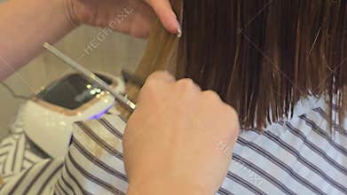 Trimming the ends of hair with scissors. Hairdressing at a beauty salon