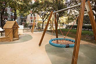 Modern urban playground with empty basket swing on a sunny autumn day