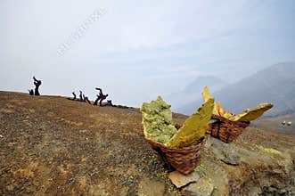 Solid sulfur chunk in a basket waiting to be carried out