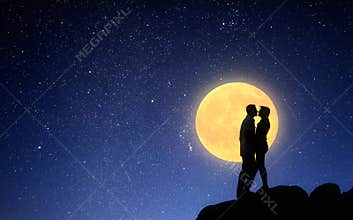 Loving couple kissing on a moonlit night