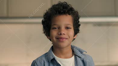 Portrait face of little African boy happy smiling toothy dental American ethnic child son kid cute smile at home looking