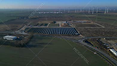 Solar panels wind turbines generating renewable energy. Magic aerial view drone