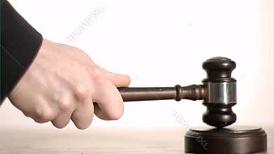 Gavel in slow motion hitting a sound block