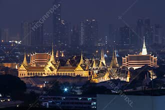 The Supreme Grand Palace is a complex of buildings at the heart of Bangkok, Thailand. Golden illuminated temple complex at night