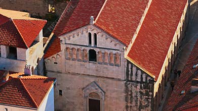 Aerial drone view of an old stone church facade with arched