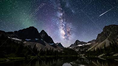 The tranquil majesty of a moonlit mountain range under a clear, star filled firmament, capturing the stillness and profound
