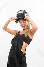 smiling woman in welder helmet