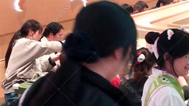 People are sitting around, enjoying a mobile hot pot