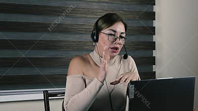 Female news anchor in headset looking at camera and speaking,