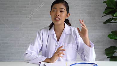 Camera view of online video conference chat with Asian female doctor and patient while discussing and diagnosing on
