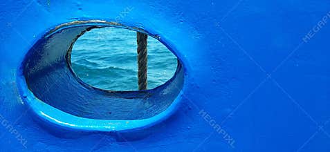 BullÂ´s eye, porthole, round window on a blue boat, ship, ferry