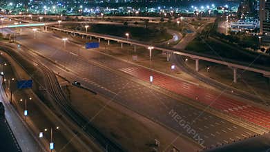 Aerial night view of empty highway and interchange without cars in Dubai
